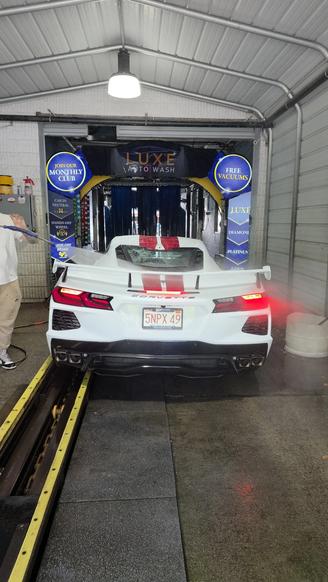 A car lined up at the Luxe Auto Wash tunnel entrance